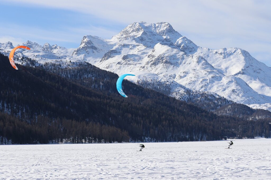Snowkiting on the frozen Lake Silvaplana with a view of Piz da la Margna.